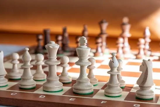 Wooden chess pieces on a chessboard at NOVA chess classes in Kuala Lumpur