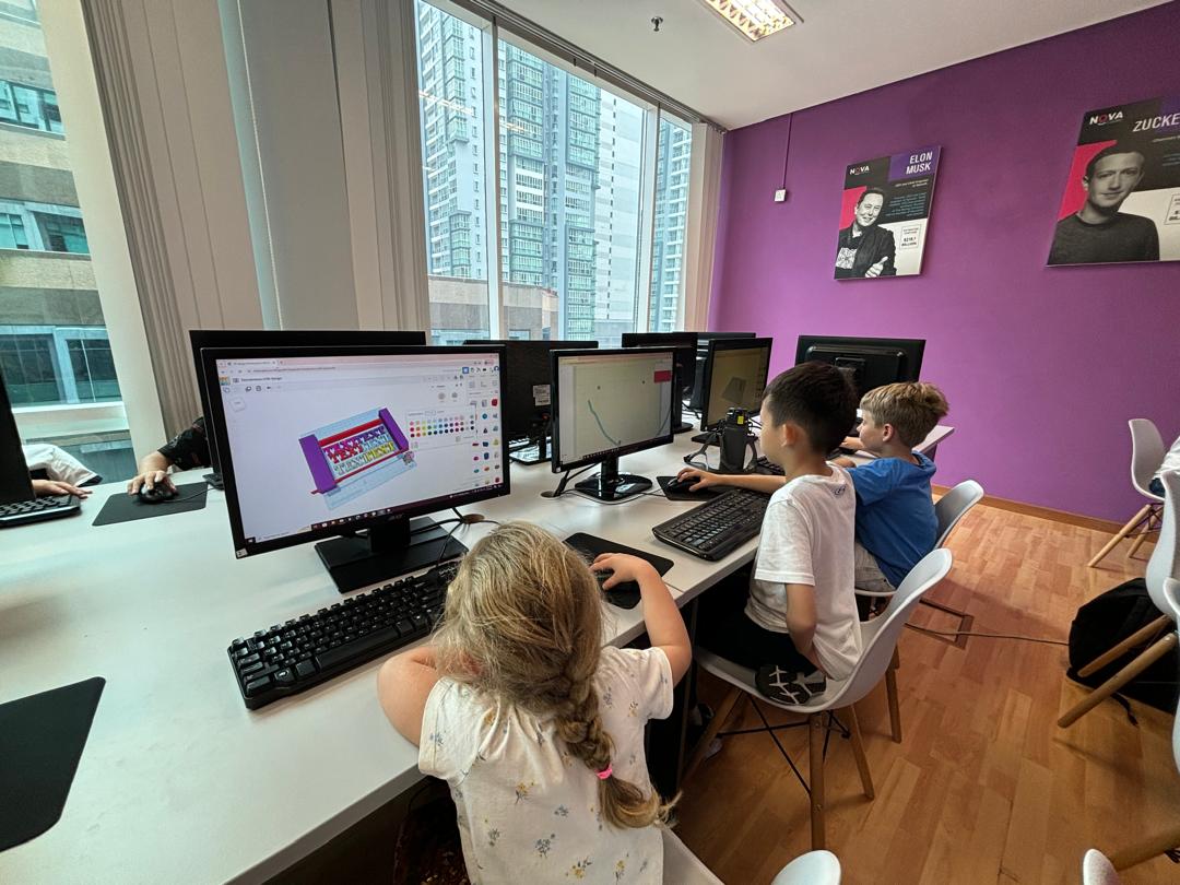 Students designing a 3D model with a view of the KLCC skyline