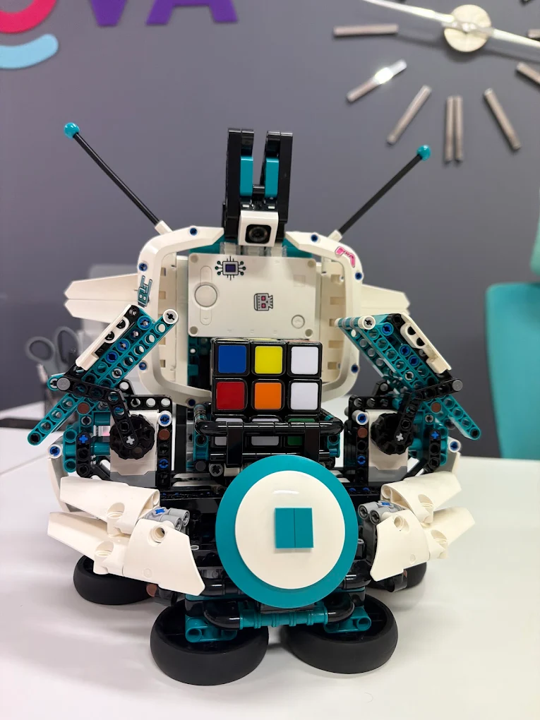 A LEGO robot built by students, holding a Rubik’s cube