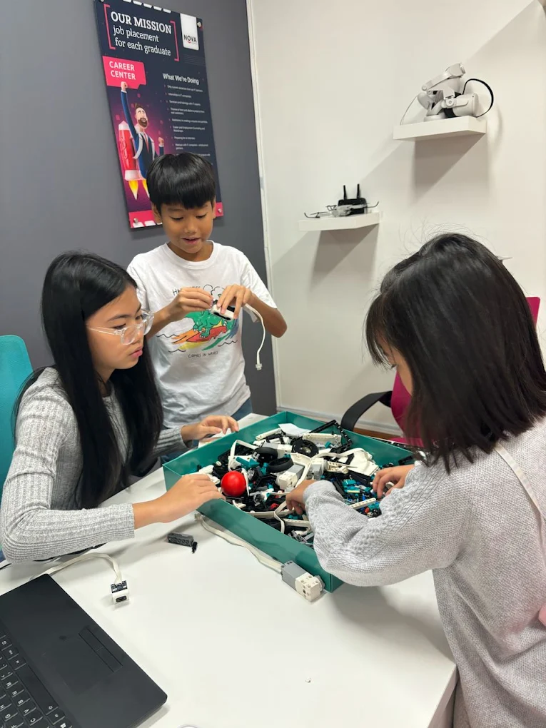Students building a robotics kit together