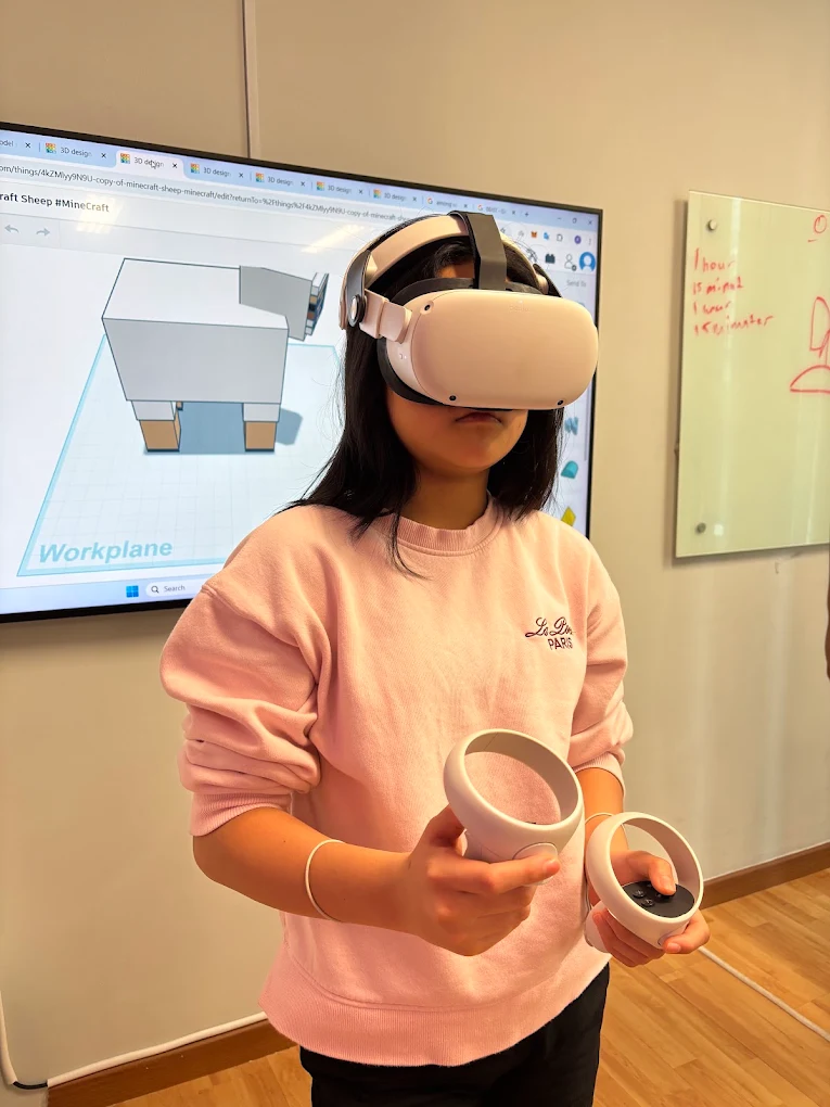 A student wearing a VR headset while building a 3D world
